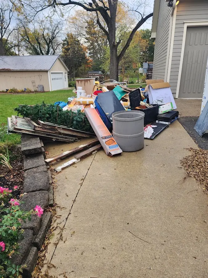 Dumpster being loaded with debris for Estate Cleanout Dumpster Rental in Virginia